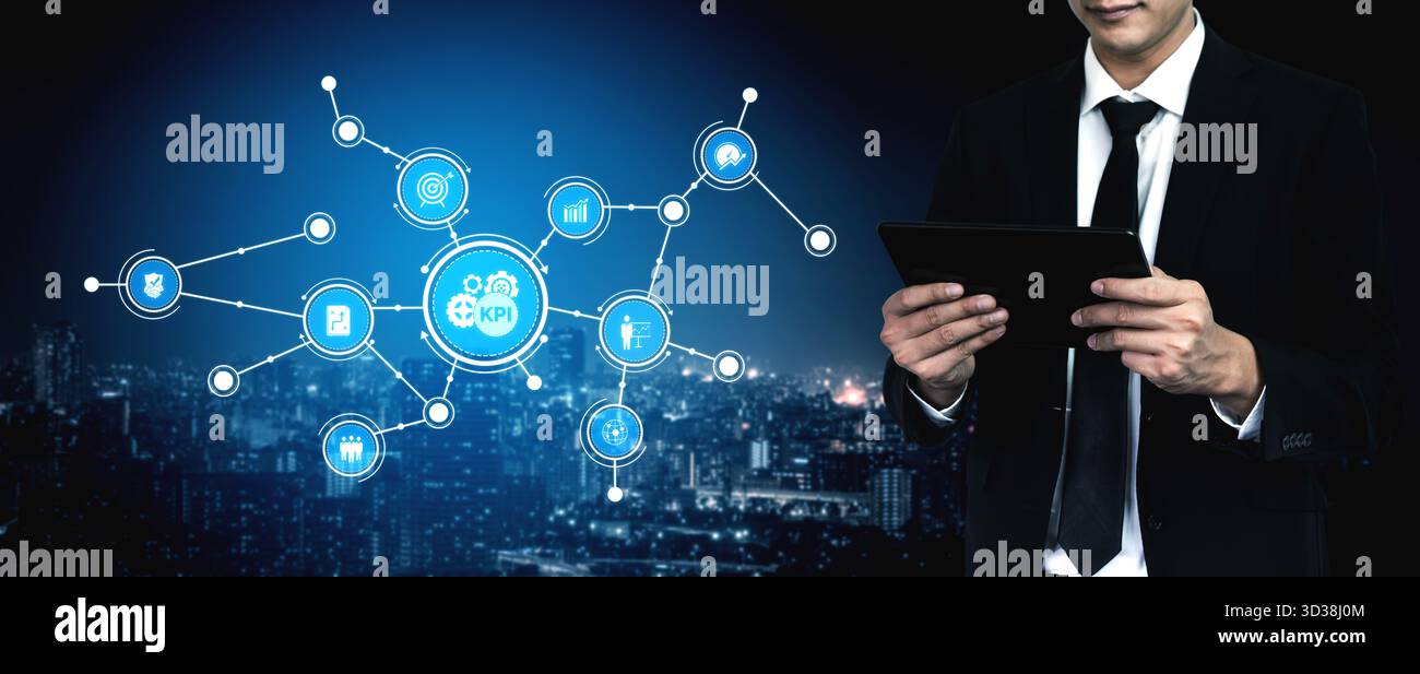 A business professional interacts with a digital tablet, analyzing key performance indicators in a modern urban setting, highlighting data-driven Stock Photo