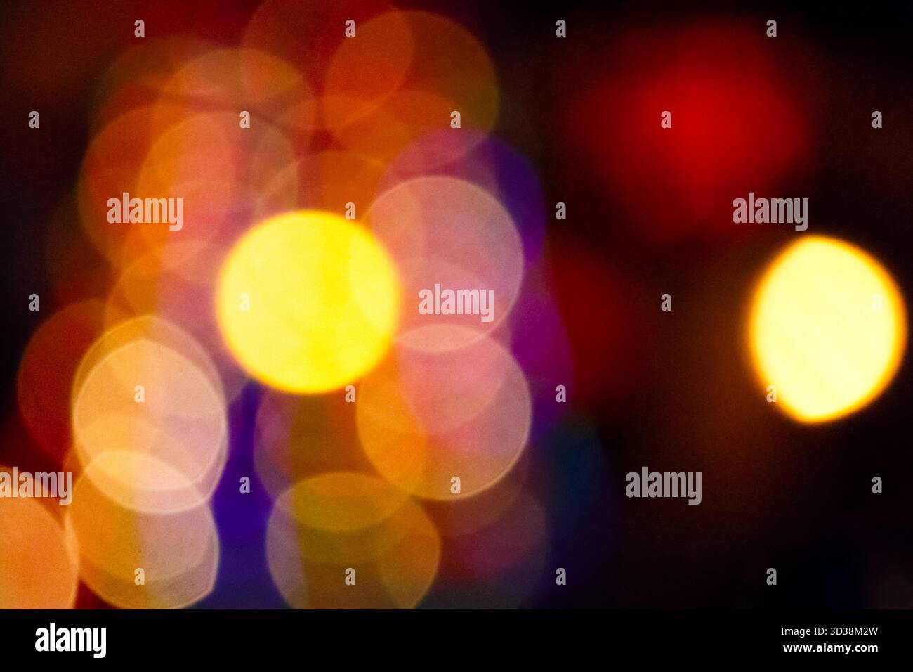 winter holiday colorful bokeh. festive decorated christmas tree lights on city street for beautiful new year abstract background. defocused red and ye Stock Photo