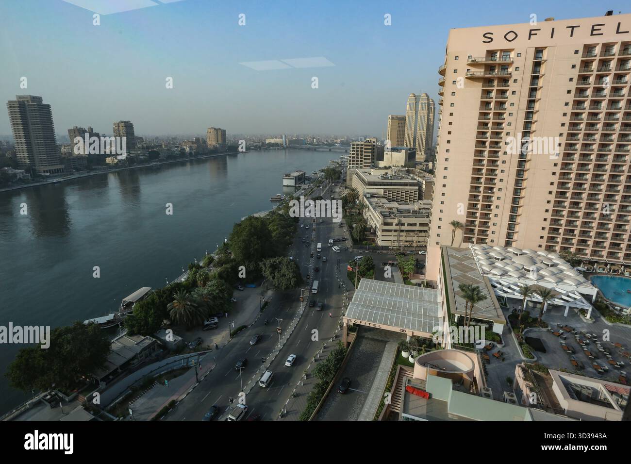 An elevated view of Cairo's Nile Corniche captures the river, traffic ...