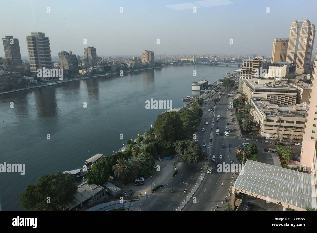 An elevated view of Cairo's Nile Corniche captures the river, traffic ...