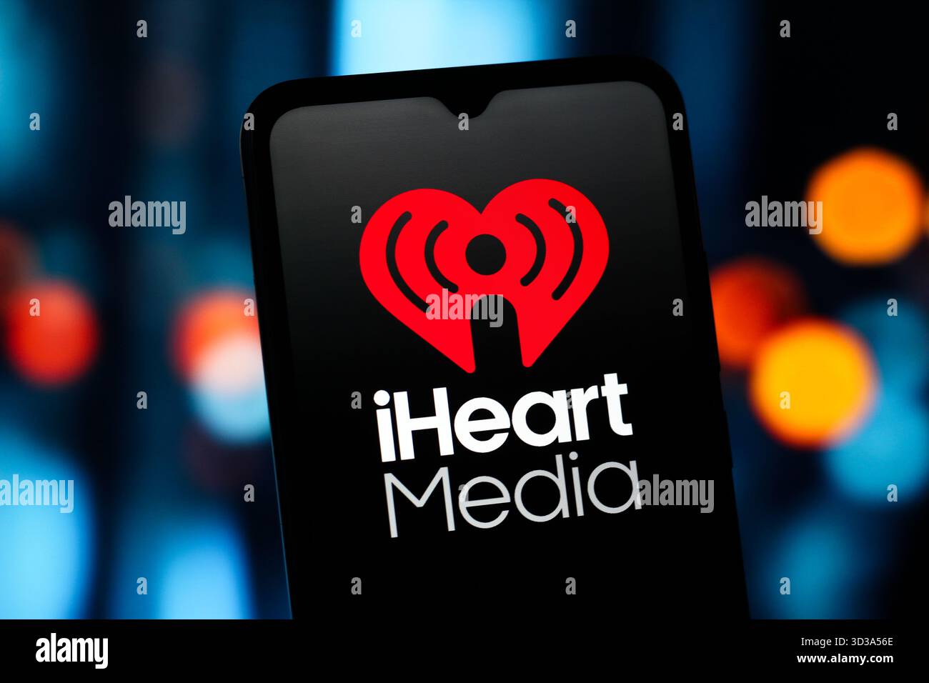 In this photo illustration, the iHeartMedia (i Heart Media) logo is seen displayed on a smartphone screen. Stock Photo