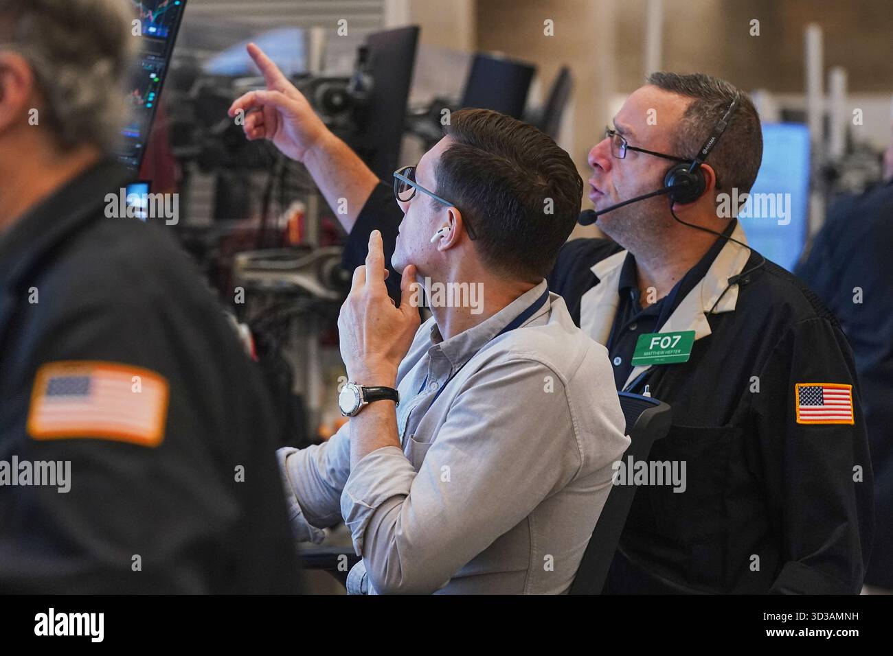 Options trader Matthew Hefter, right, works on the floor of the New ...