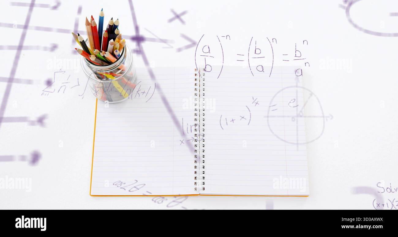 Showing open spiral notebook on white desk, with glass jar holding colored pencils, math overlays Stock Photo