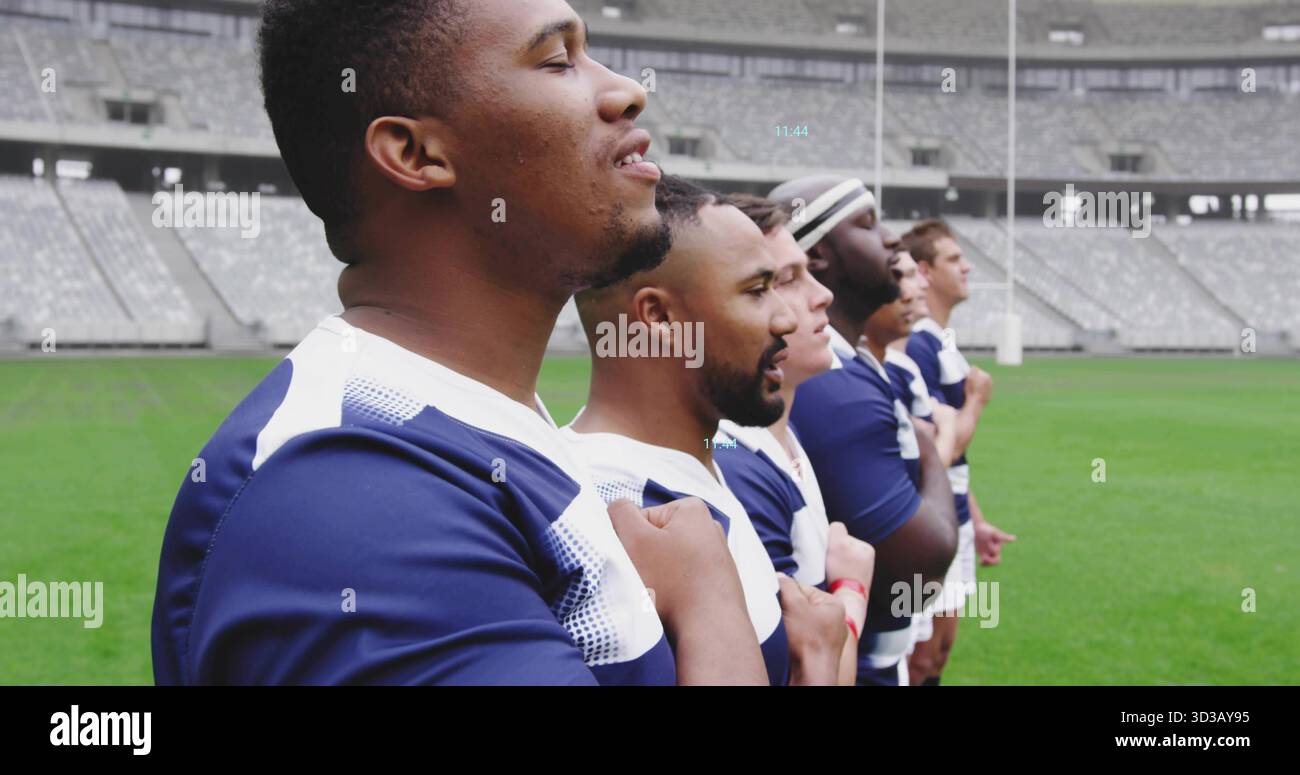 Standing eight rugby players holding right hands over chests on pitch ...