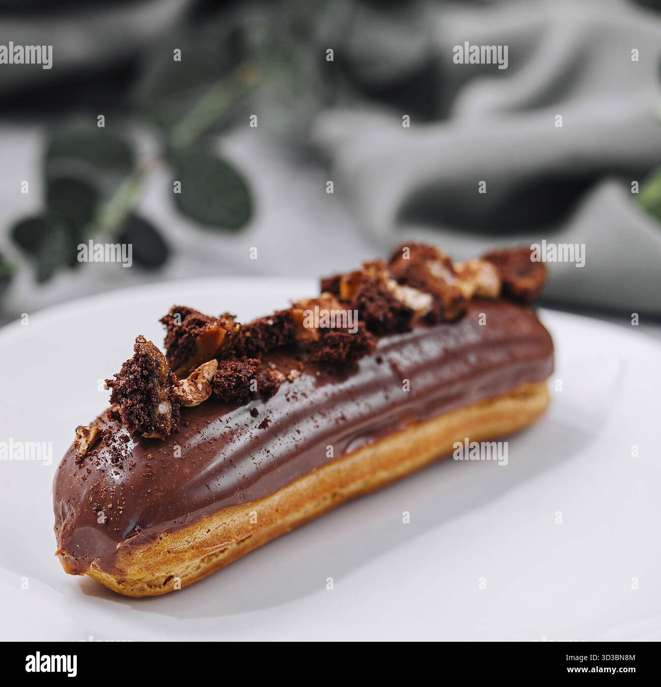 Food, Eclair with Chocolate Cream and Hazelnuts Stock Photo