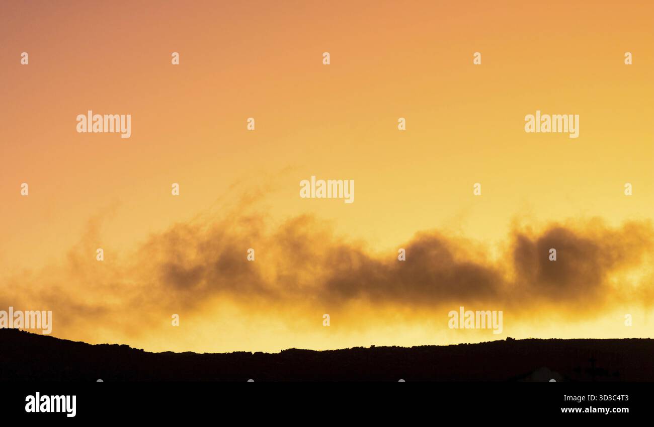 Cumulus and Stratus clouds in dramatic sunset sky over Cape Town Stock Photo
