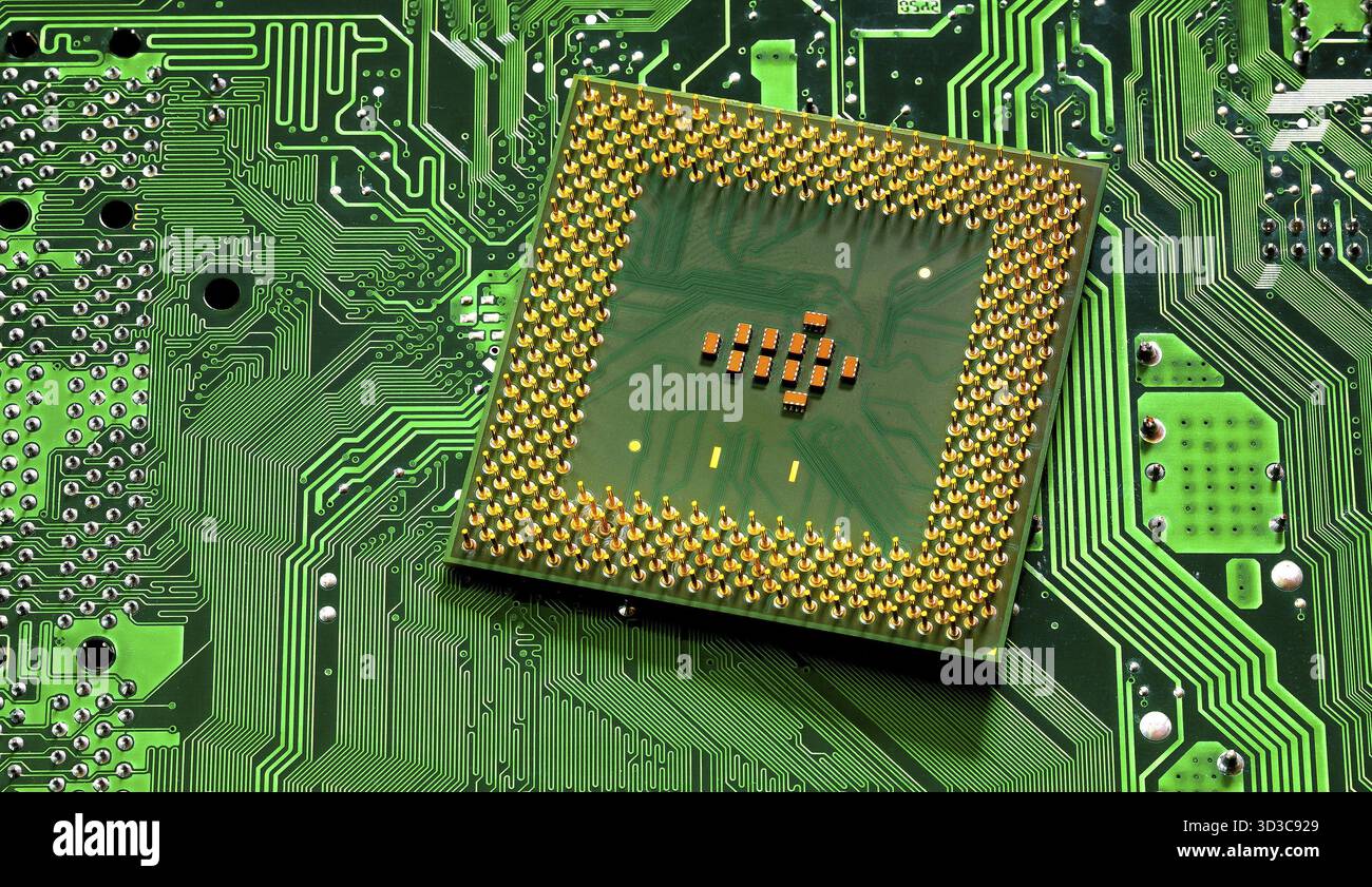 Macro Close up of microchips and pins on Main CPU PC processor circuit board Stock Photo
