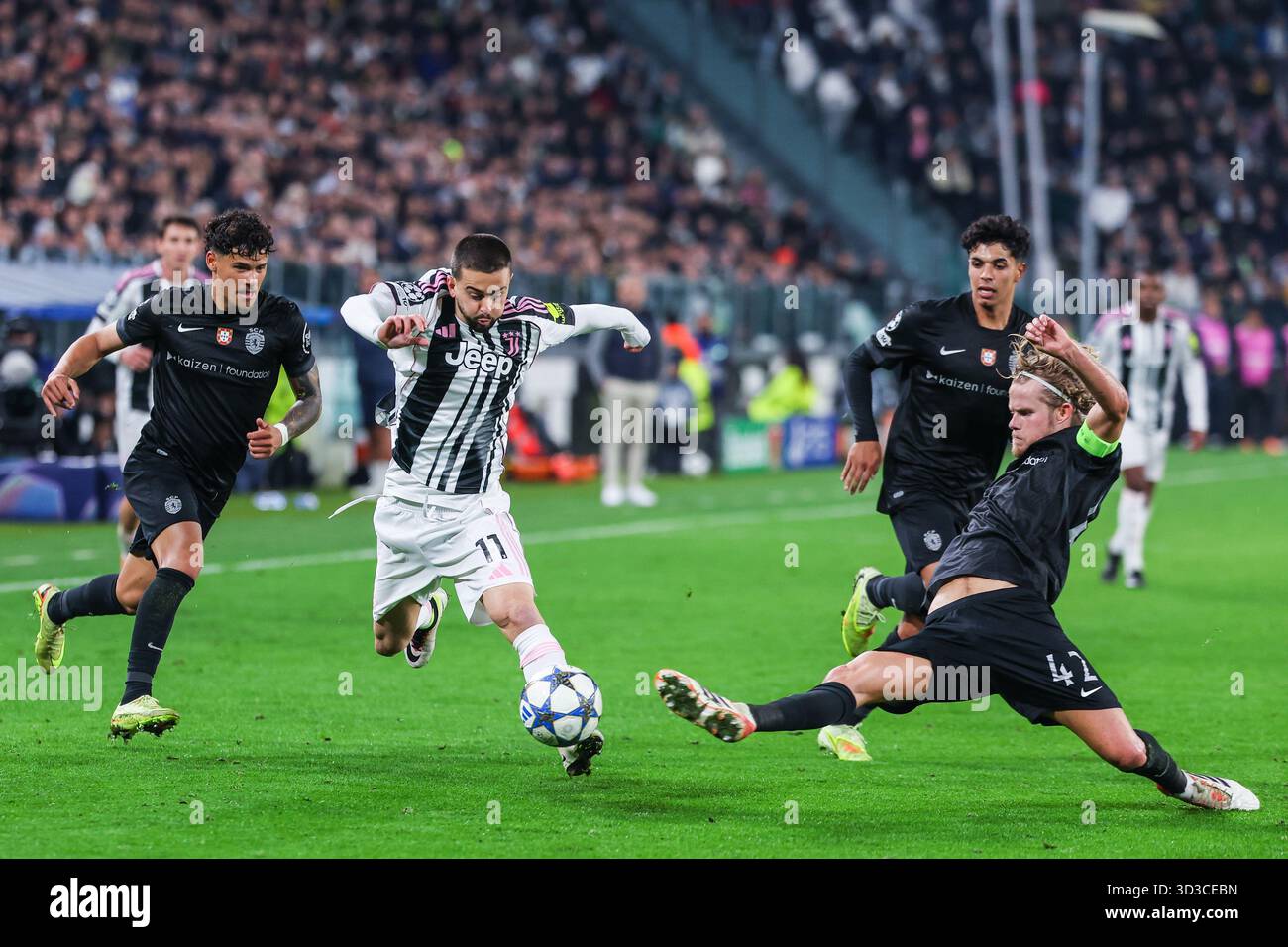 (C) Edon Zhegrova of Juventus FC,  (R) Morten Hjulmand of Sporting CP and (L) Pedro Goncalves of Sporting CP are seen in action during UEFA Champions League 2025/26 League Phase - Matchday 4 football match between Juventus FC and Sporting CP at Allianz Stadium in Turin. Final score; Juventus FC 1 : 1  Sporting CP. Stock Photo