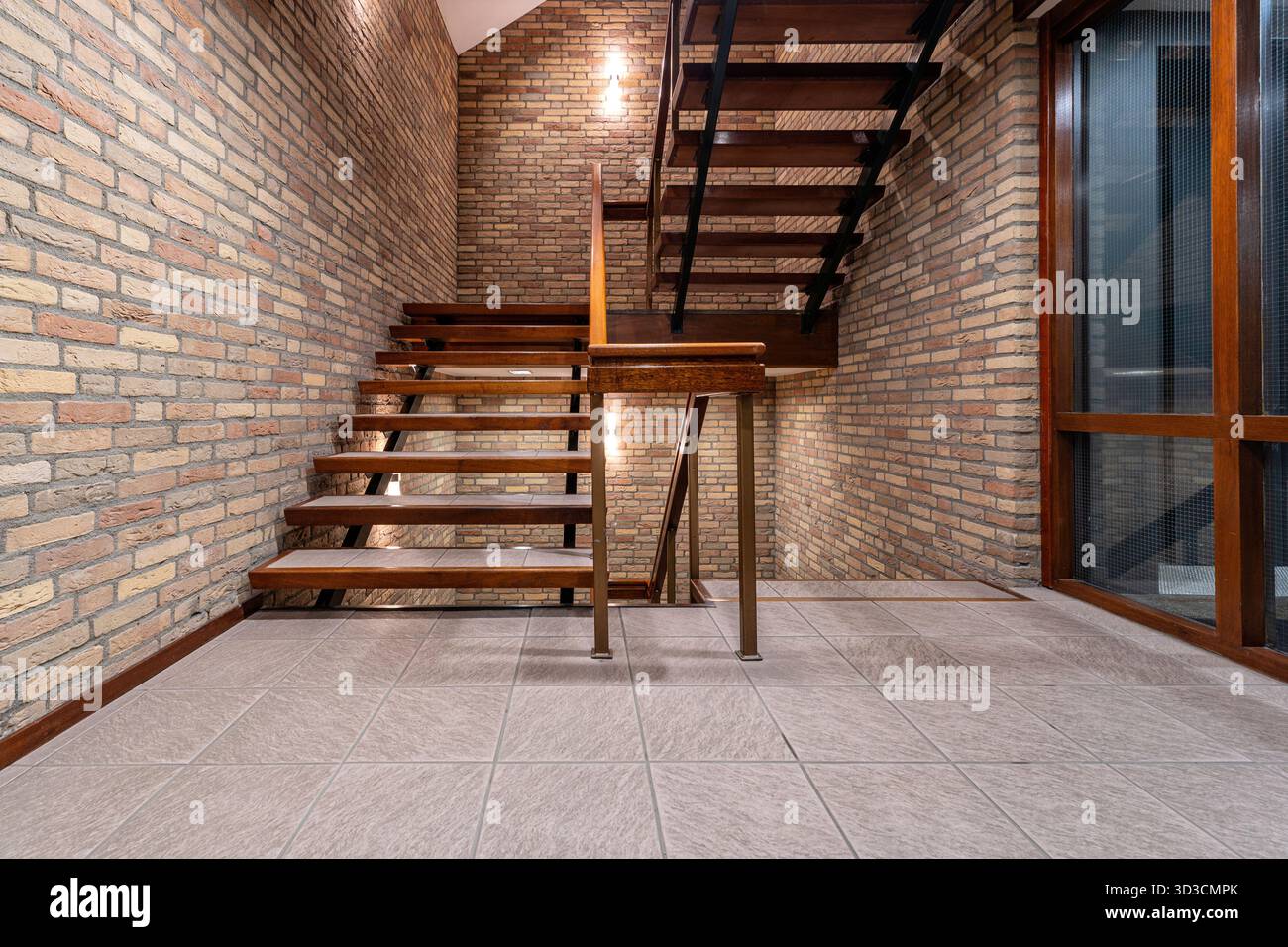 interior staircase with tiles, bricks and wood Stock Photo