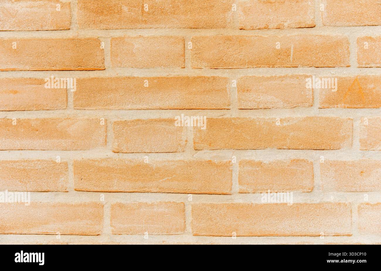 Orange brick wall background texture with rectangular pattern and grunge look. Stock Photo
