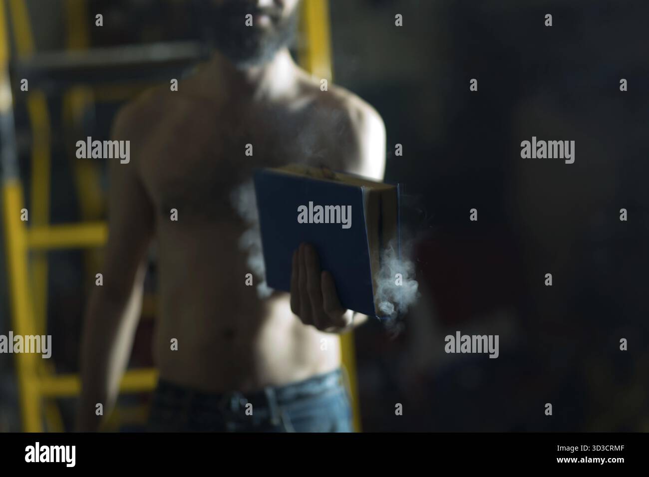 Man hold burning book in his hands Stock Photo