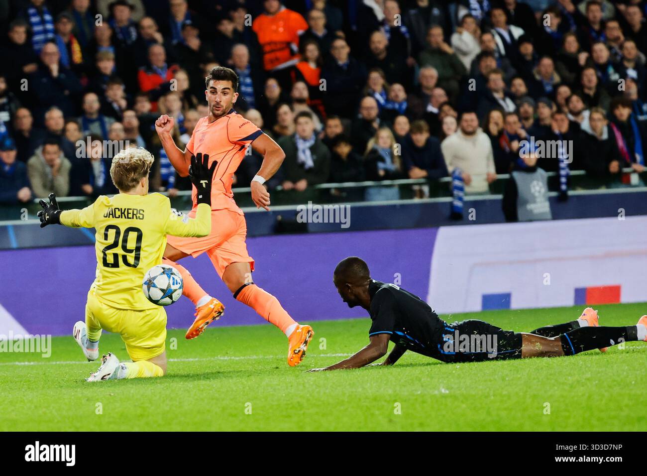 Barcelona's Ferran Torres, center, takes a shot on goal as Brugge's