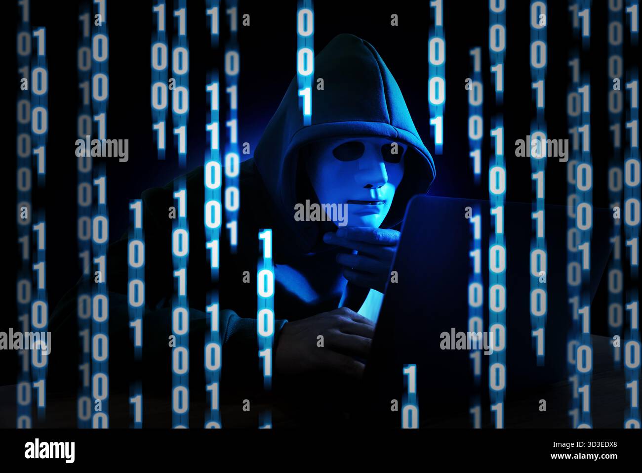 Cyber attack. Hacker in mask using laptop. Blue glowing binary code around him Stock Photo