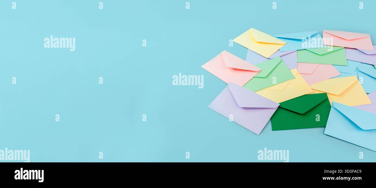 Multicolor envelopes on a blue background, a place for text, the concept of messages and subscriptions Stock Photo