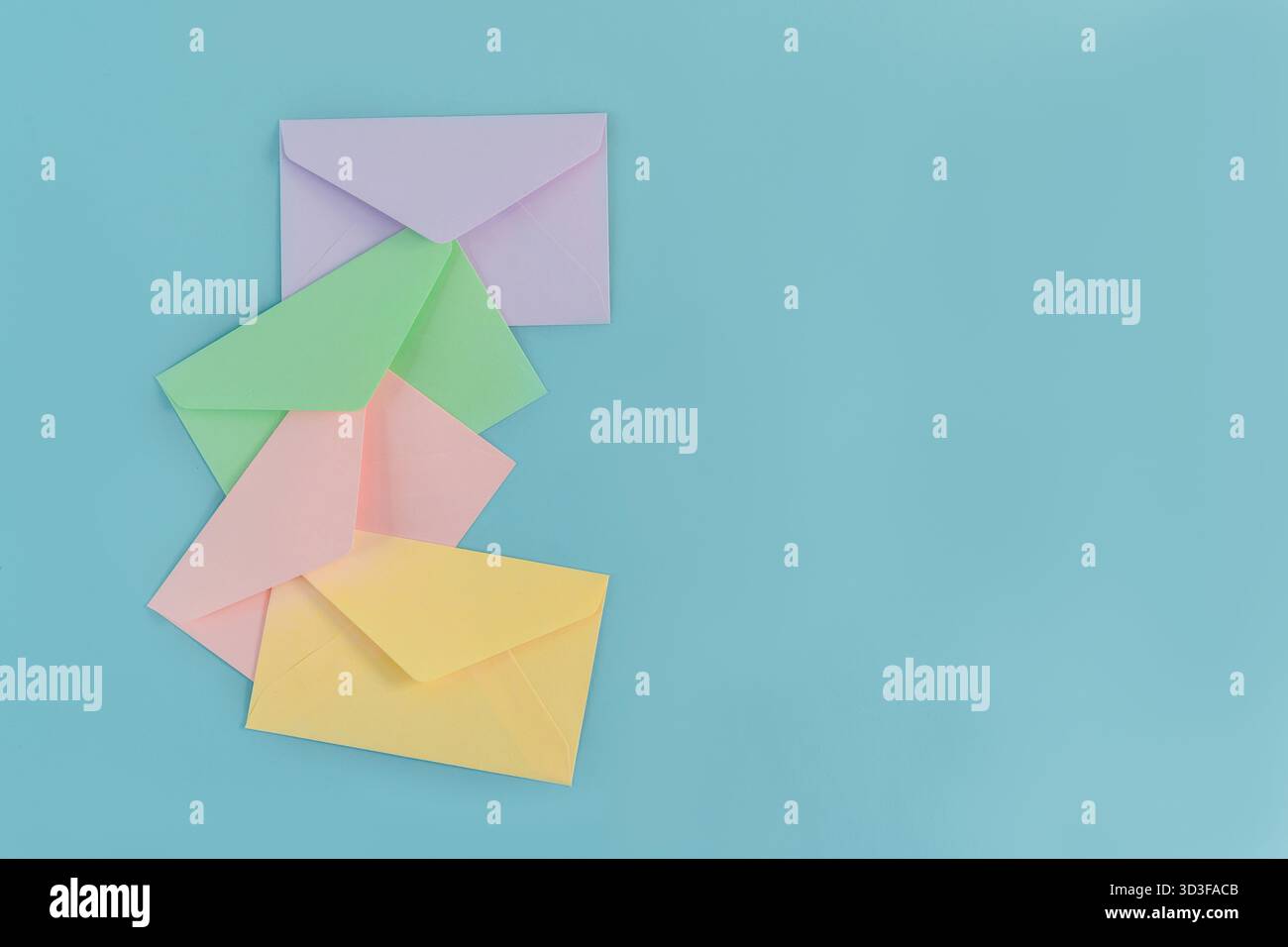 Multicolor envelopes on a blue background, a place for text, the concept of messages and subscriptions Stock Photo