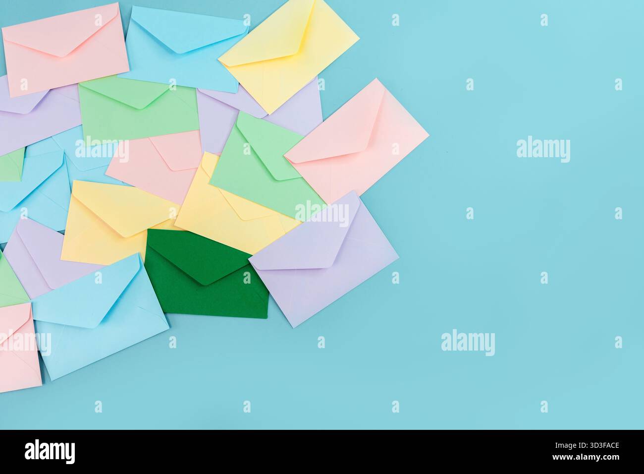 Multicolor envelopes on a blue background, a place for text, the concept of messages and subscriptions Stock Photo