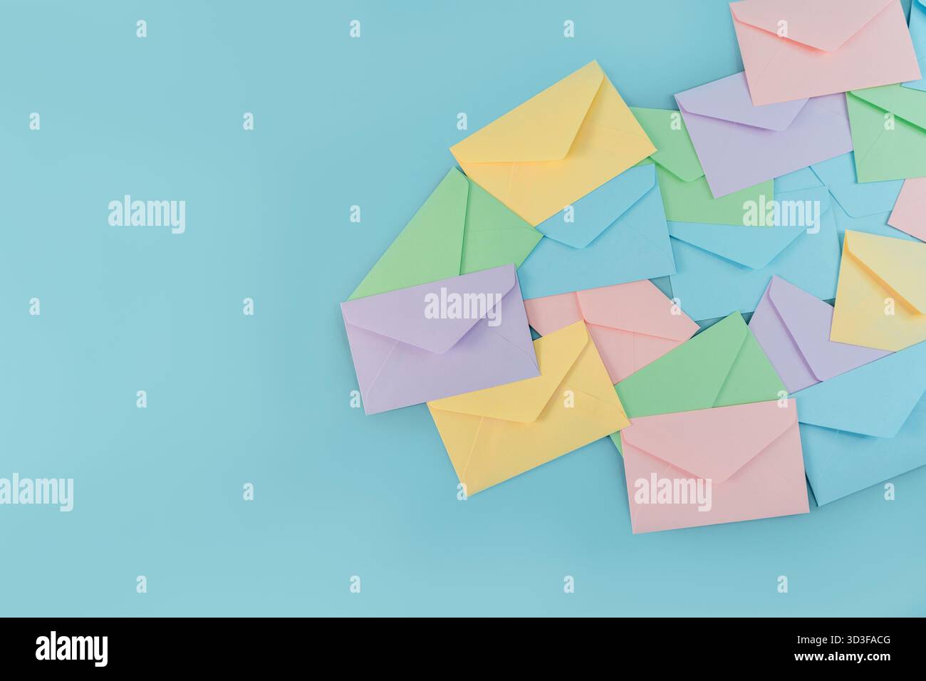 Multicolor envelopes on a blue background, a place for text, the concept of messages and subscriptions Stock Photo