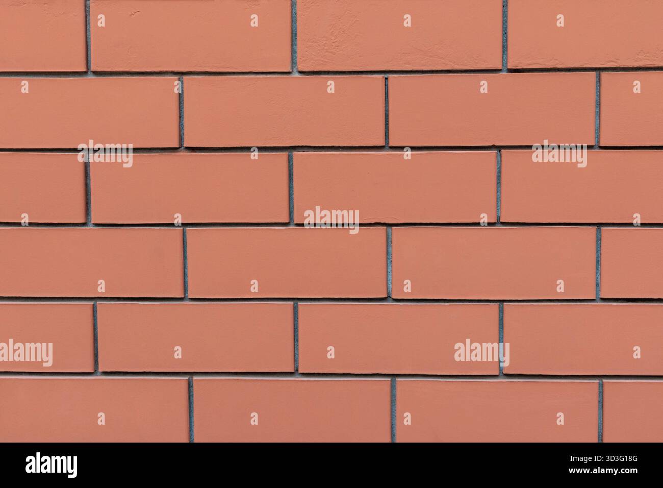 A close-up image of a red brick wall displaying a classic rectangular pattern with visible mortar lines. The bricks have a smooth texture, creating a Stock Photo