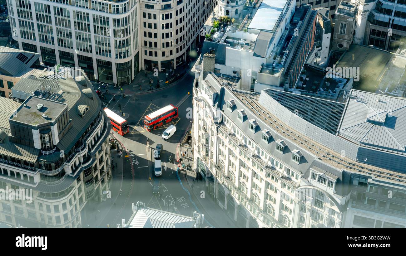 Aerial view of London's bustling City district featuring two iconic red ...