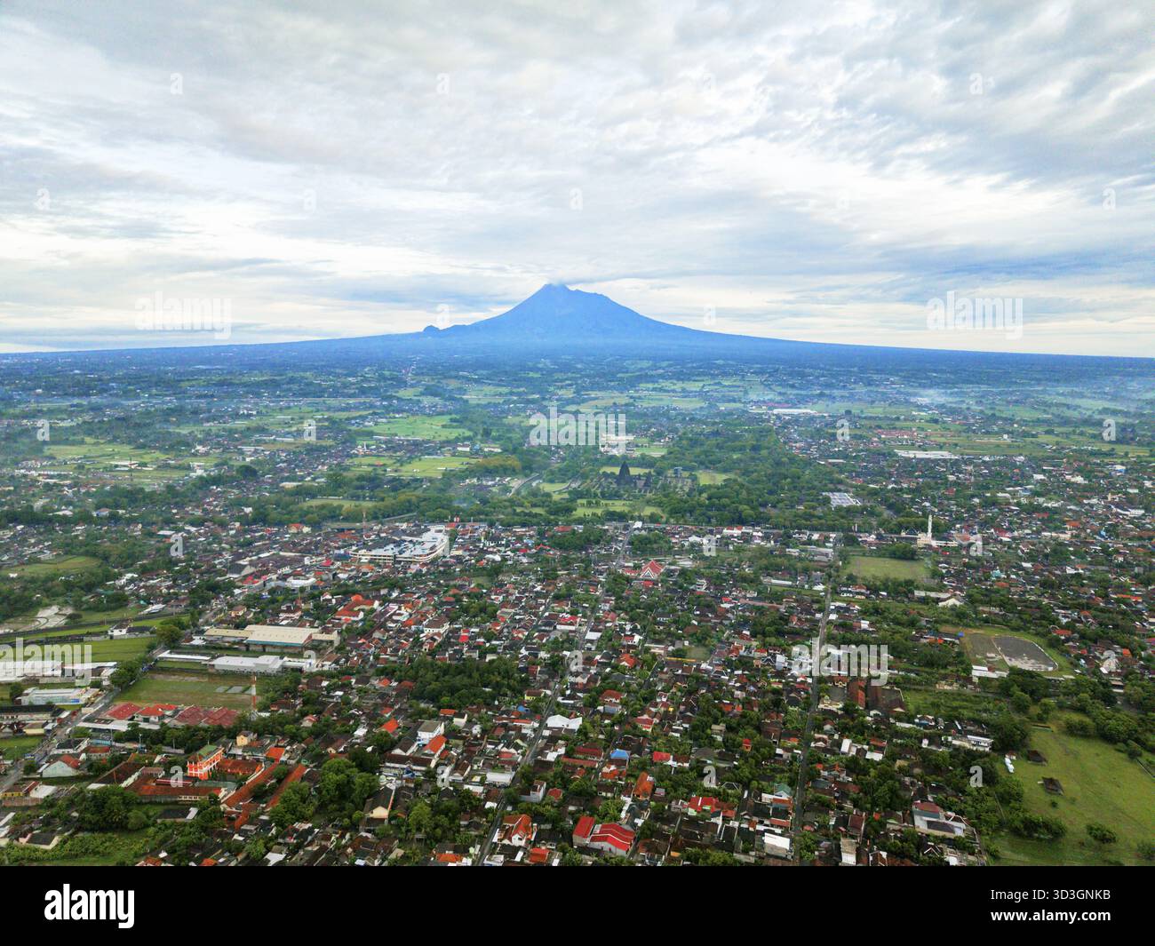 Aerial view of Mount Merapi stands majestically amidst a sprawling ...