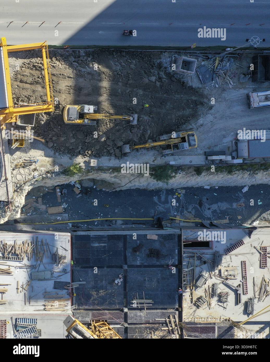 Aerial view of a construction site with yellow diggers and heavy ...