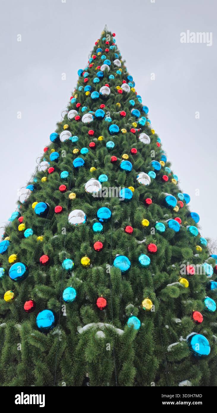Large Christmas tree decorated with multi-colored balls, view from below Stock Photo