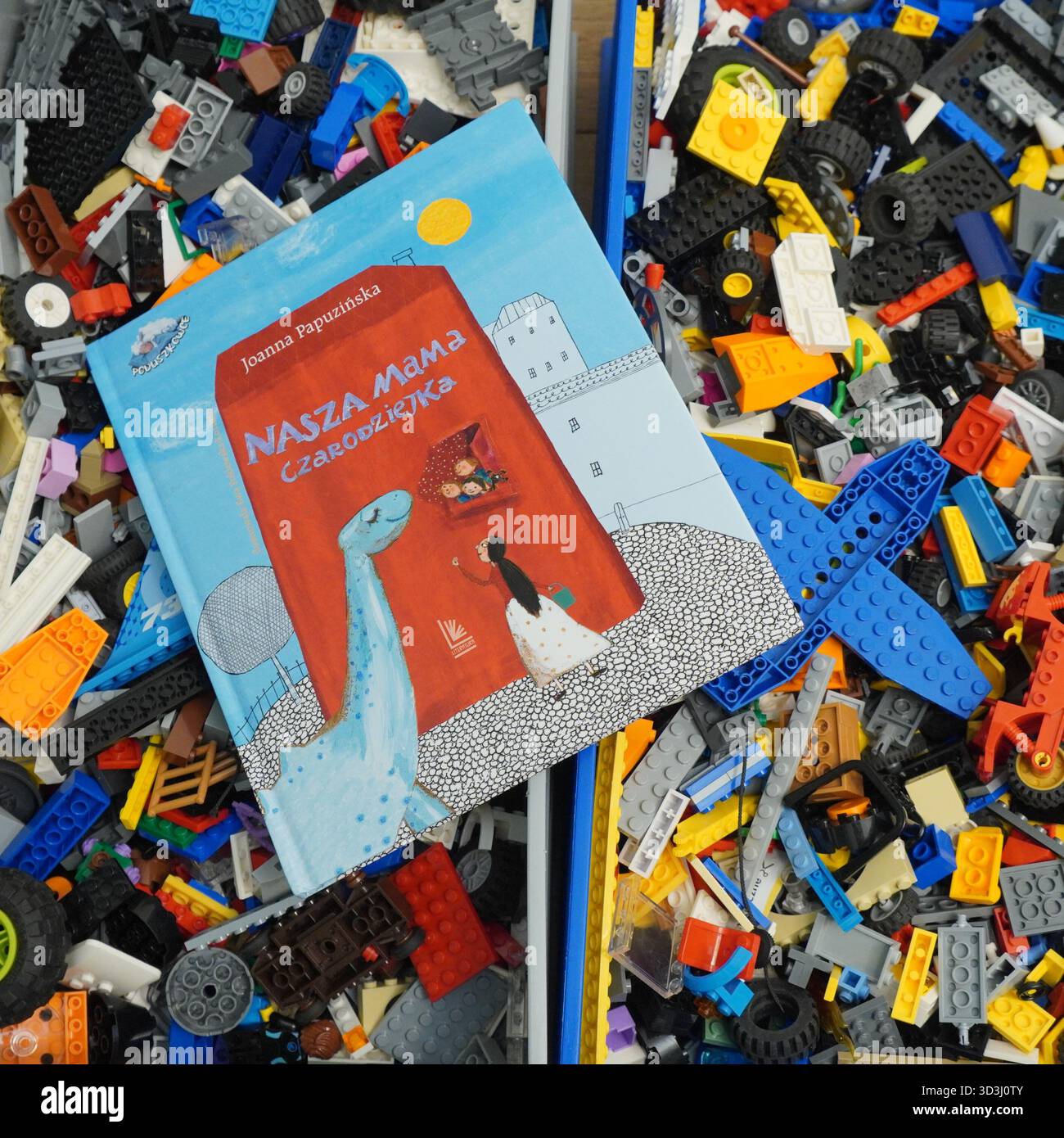 A book laying on Lego bricks Stock Photo
