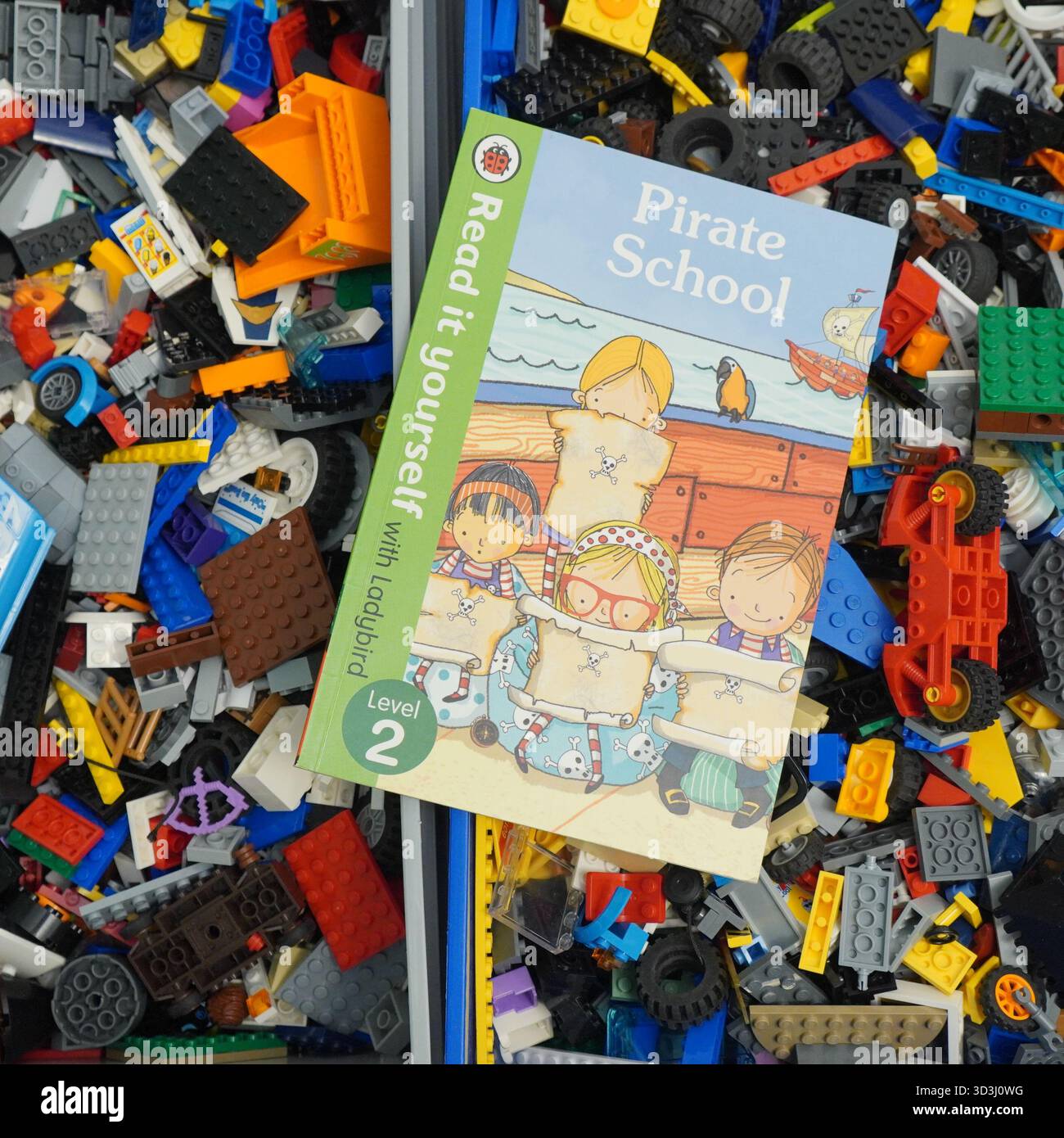 A book laying on Lego bricks Stock Photo