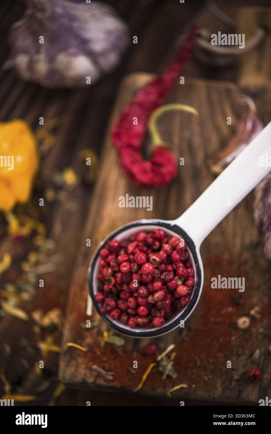 Red pepper whole seeds on spoon Stock Photo