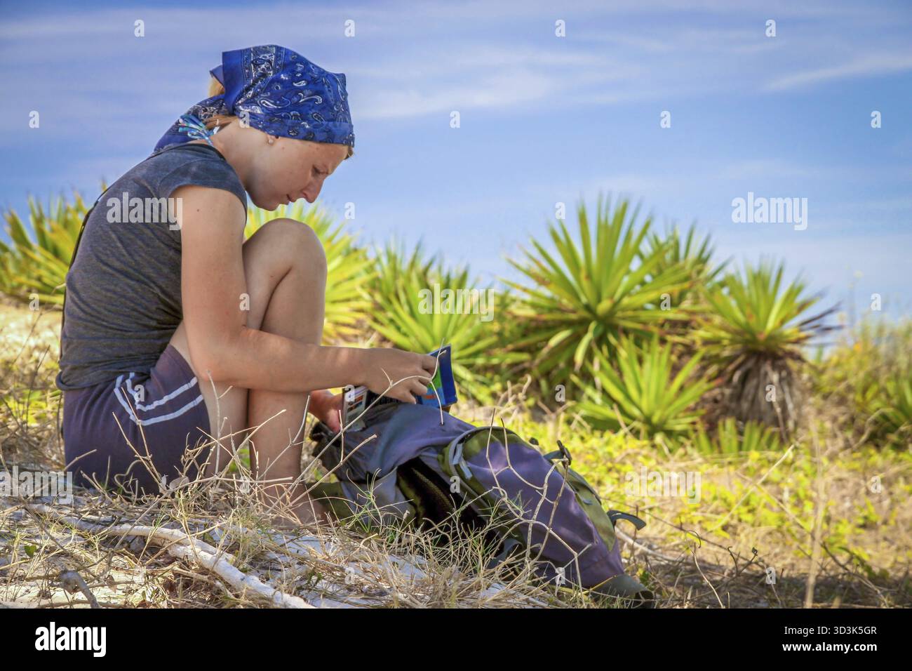 Girl seating in the shadow relaxing and reading a book Stock Photo - Alamy