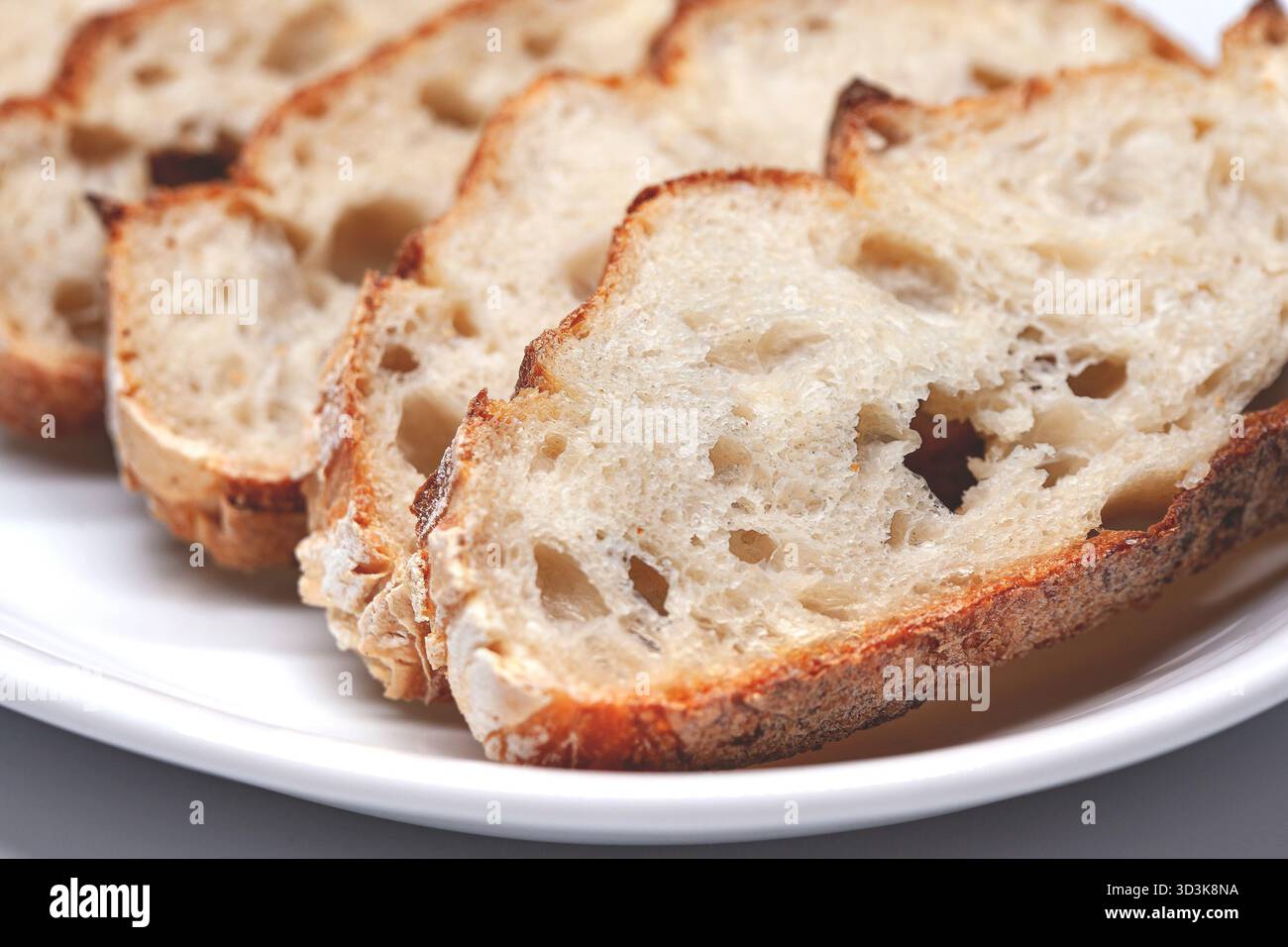 Slices of bread on a white plate Stock Photo