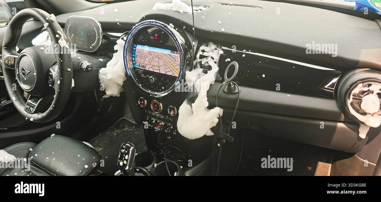 Berlin, Germany - June 08, 2025: . Mini Cooper's interior is covered in soap suds during a car wash cleaning process - Smartphone Captured Stock Image