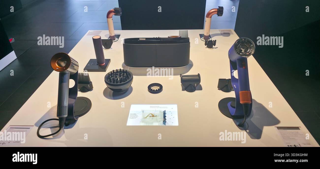 Berlin, Germany - June 17, 2025: Modern hair styling tools are arranged on a sleek white table in a showroom. - Smartphone Captured Stock Image