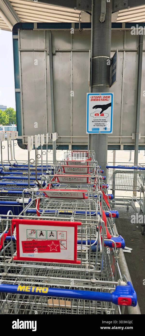 Berlin, Germany - June 21, 2025: Shopping carts are neatly arranged outside the store with signage visible above. - Smartphone Captured Stock Image