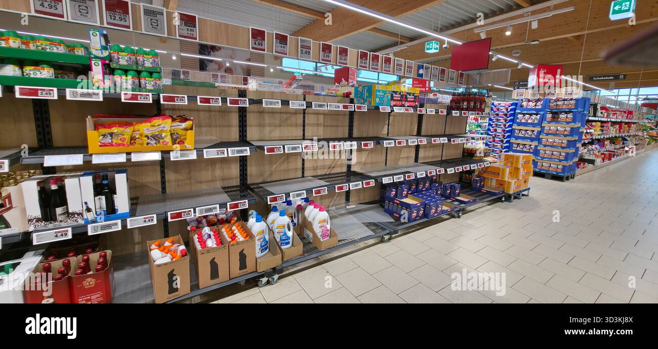 Berlin, Germany - June 28, 2025: Grocery store aisle shows empty shelves with few products available for customers. - Smartphone Captured Stock Image