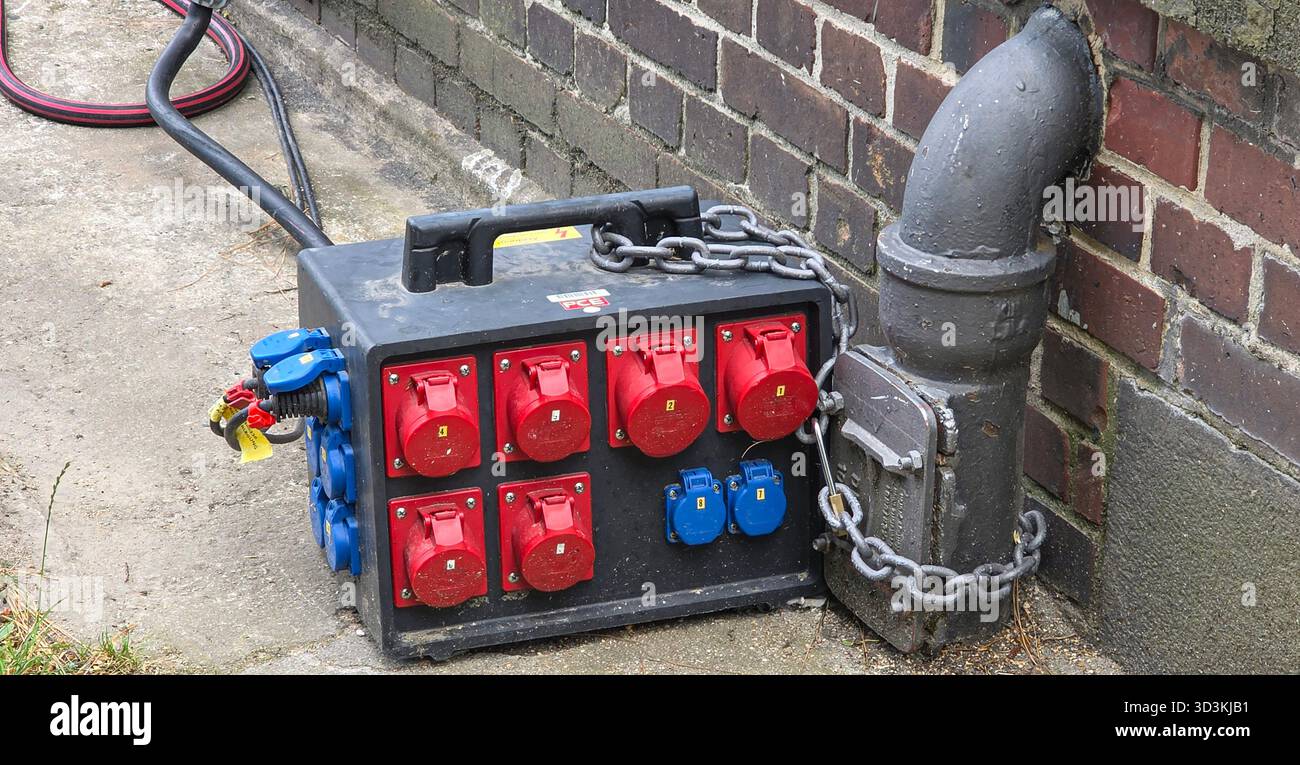 Berlin, Germany - July 03, 2025: . Electrical power distribution box features multiple outlets and cables secured to wall - Smartphone Captured Stock Image