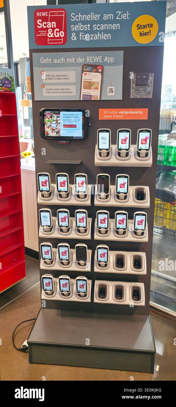 Berlin, Germany - July 04, 2025: REWE Scan & Go self-checkout kiosk features multiple devices for easy shopping and payment solutions. - Smartphone Captured Stock Image