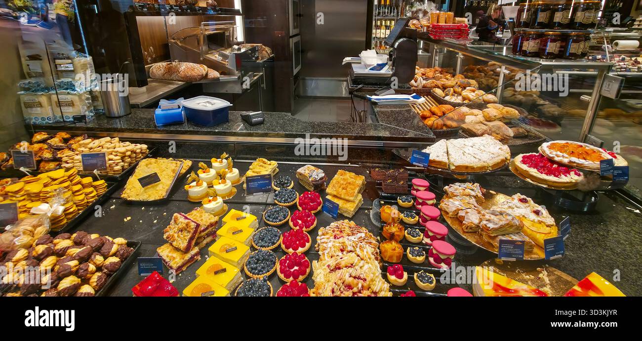 Berlin, Germany - August 07, 2025: Colorful pastry display features an array of delicious desserts and baked goods. - Smartphone Captured Stock Image