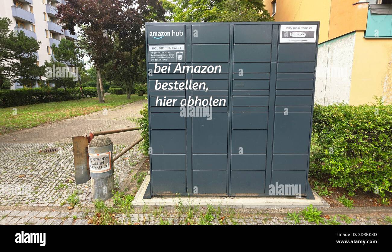 Berlin, Germany - July 14, 2025: Amazon hub package pickup station located in a green urban park area. - Smartphone Captured Stock Image