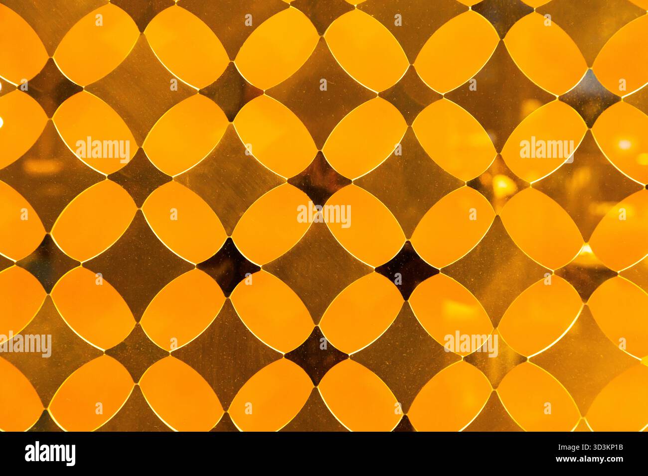 Yellow decorative translucent glass with a diamond pattern. Stock Photo