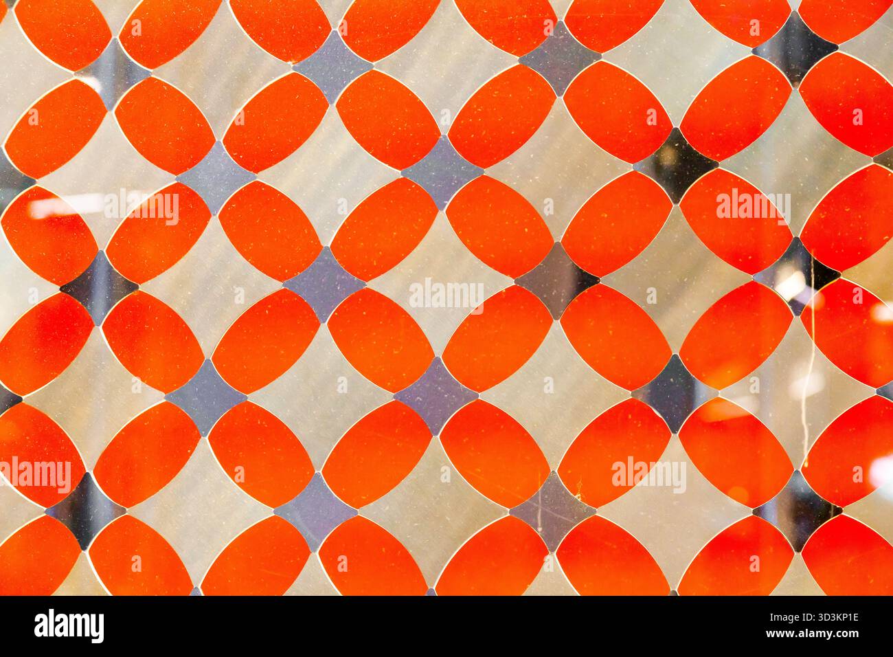 Orange decorative translucent glass with a diamond pattern. Stock Photo