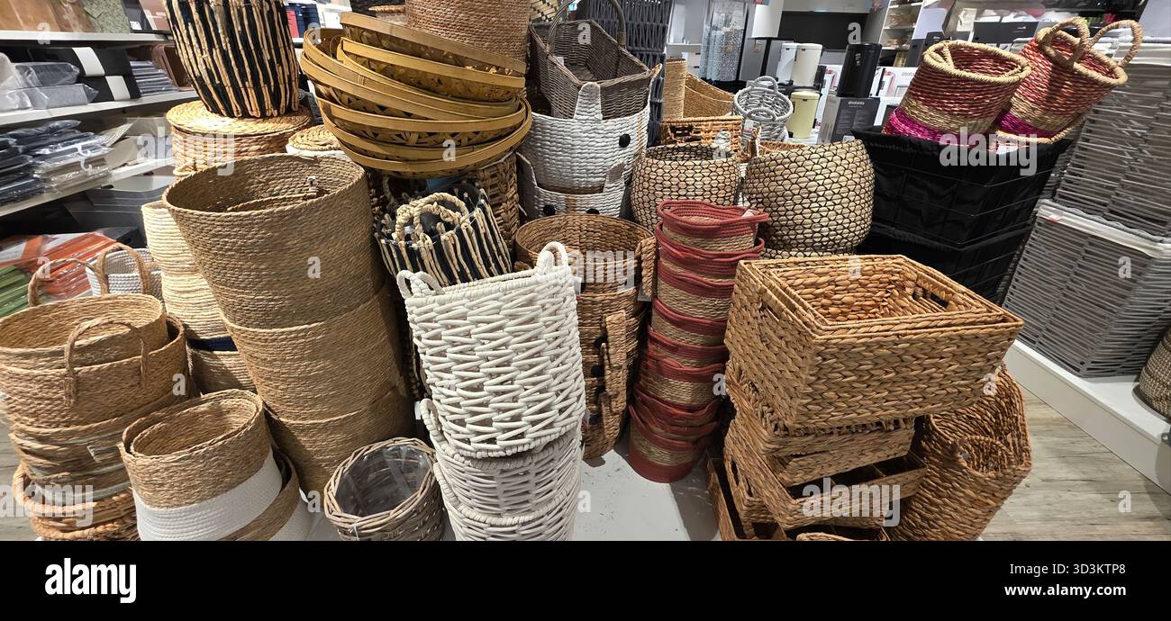 Assorted woven baskets are displayed in various shapes and sizes, showcasing natural materials and textures for home organization and decor. - Smartphone Captured Stock Image