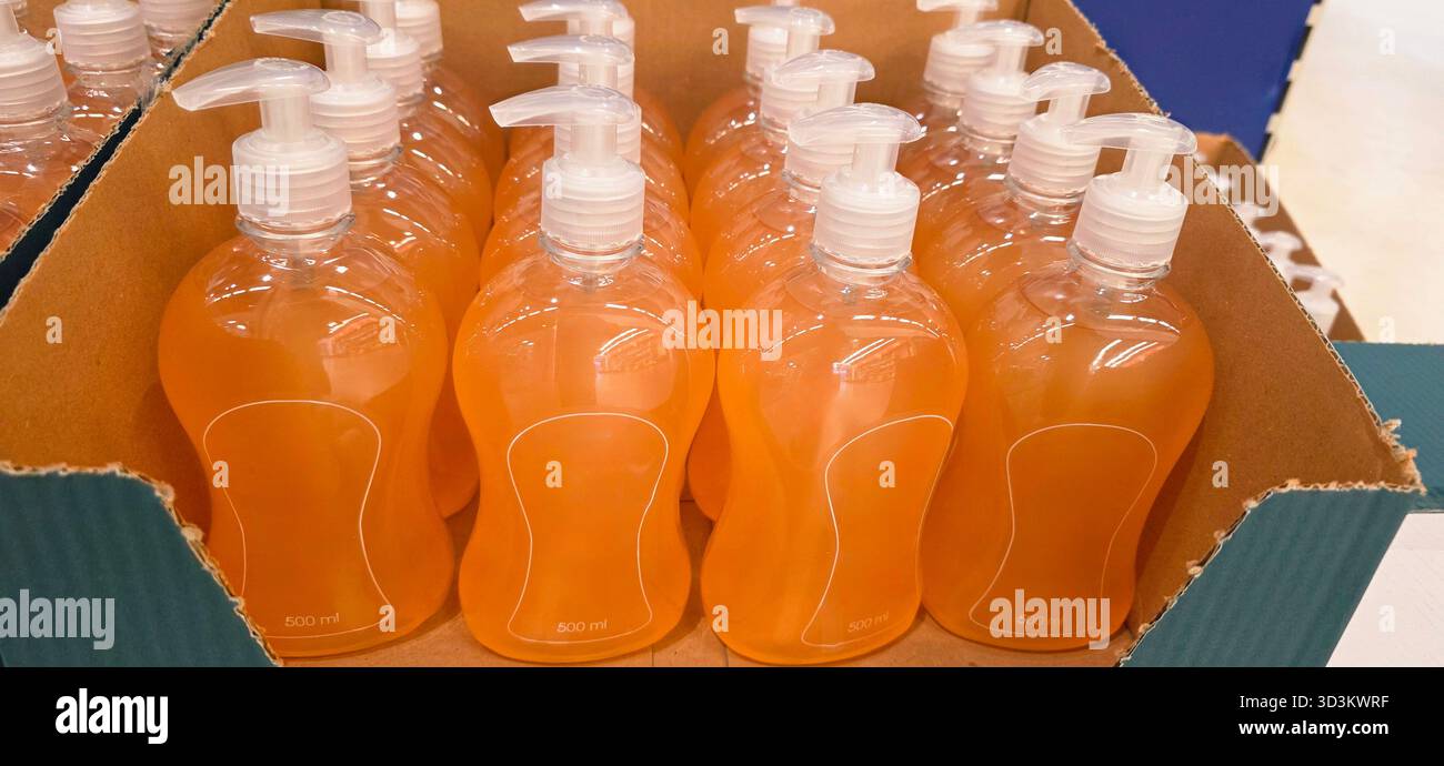 Bottles of liquid soap are neatly arranged in a cardboard box, showcasing vibrant colors and clear packaging for retail presentation. - Smartphone Captured Stock Image