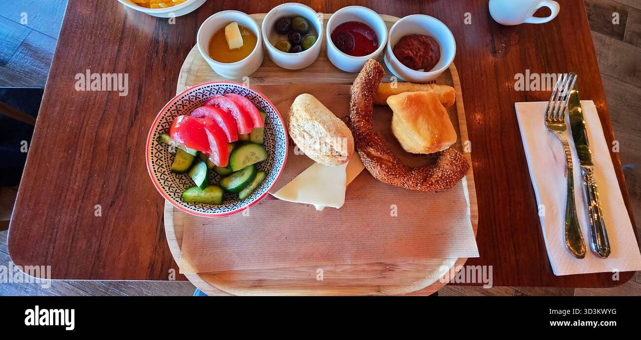 . Colorful breakfast spread featuring fresh fruits, bread, and various dips arranged on a wooden platter, creating an inviting morning meal - Smartphone Captured Stock Image