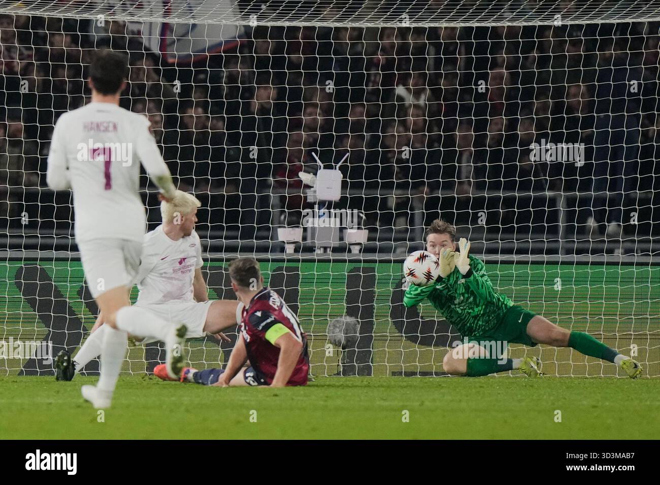 Lewis Mathias Brann's goalkeeper Mathias Dyngeland, right, saves on Bologna's Lewis ...