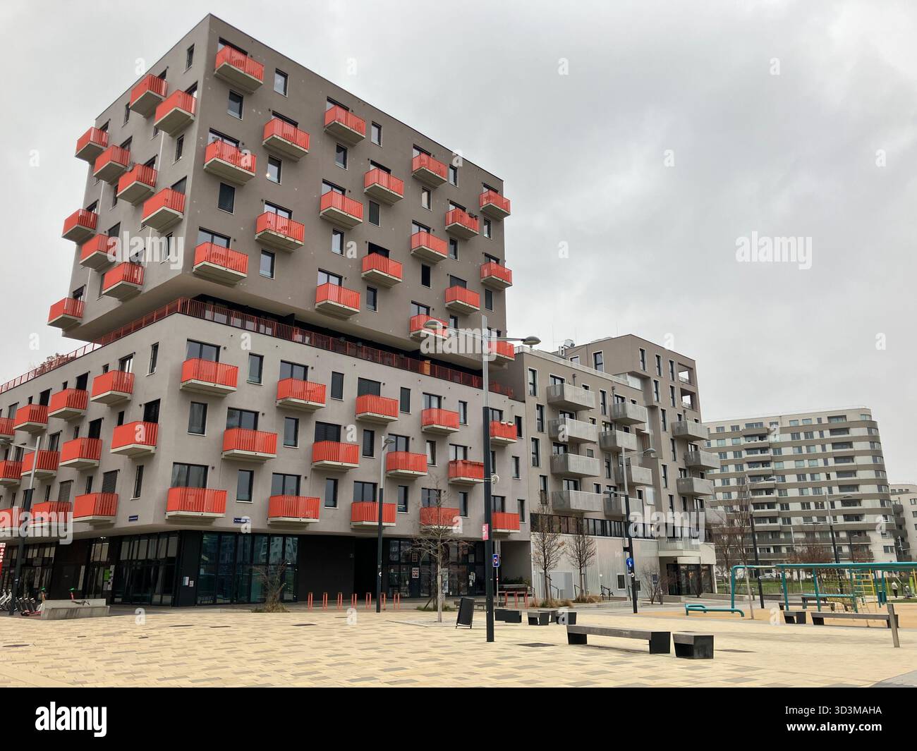 Apartment building at corner Bloch-Bauer-Promenade and Sissy-Löwinger-Weg in Sonnwendviertel neighbourhood, Favoriten district, Vienna, Austria - Smartphone Captured Stock Image