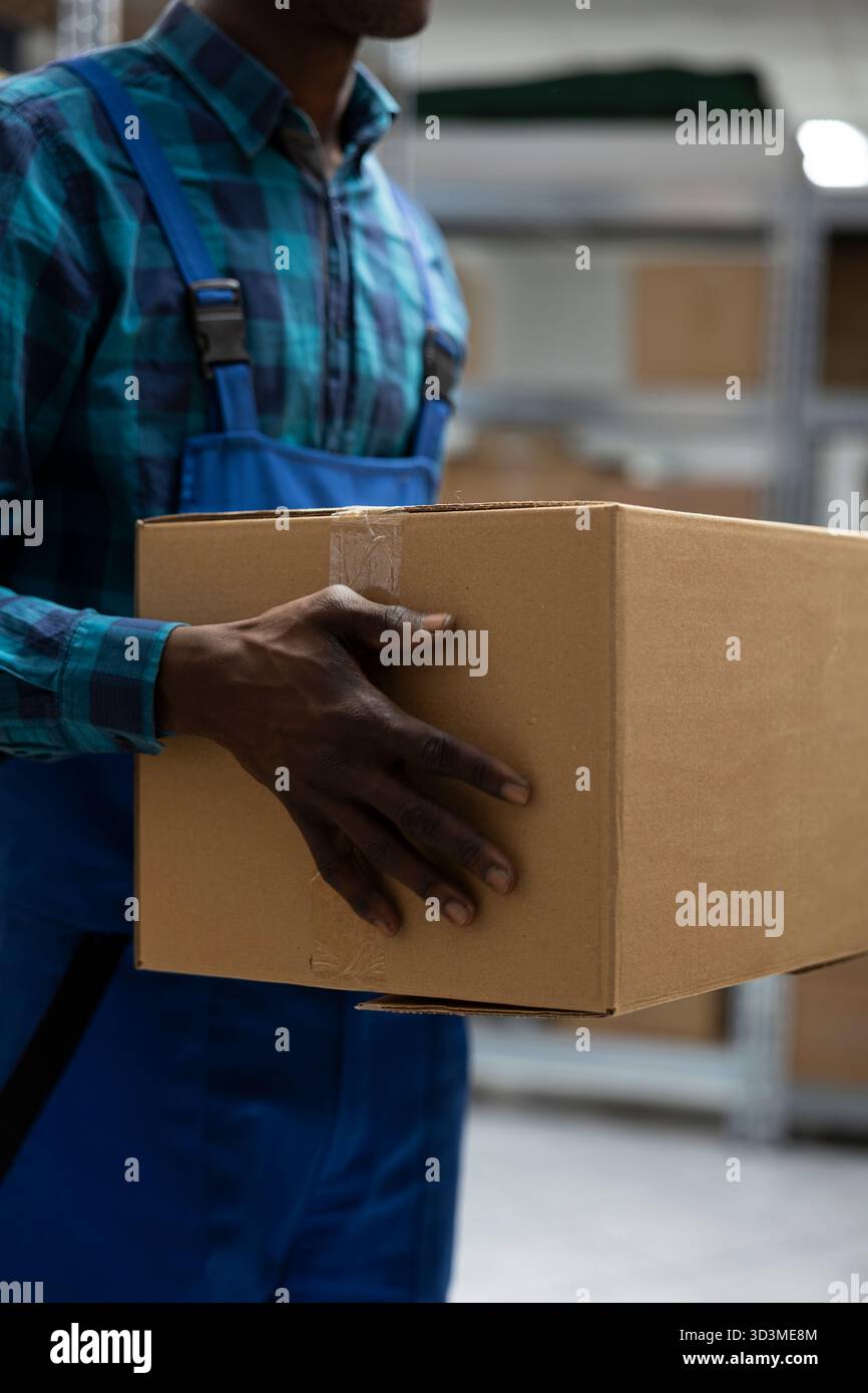 Manual labor tasks in industrial warehouse involve checking shipments ...