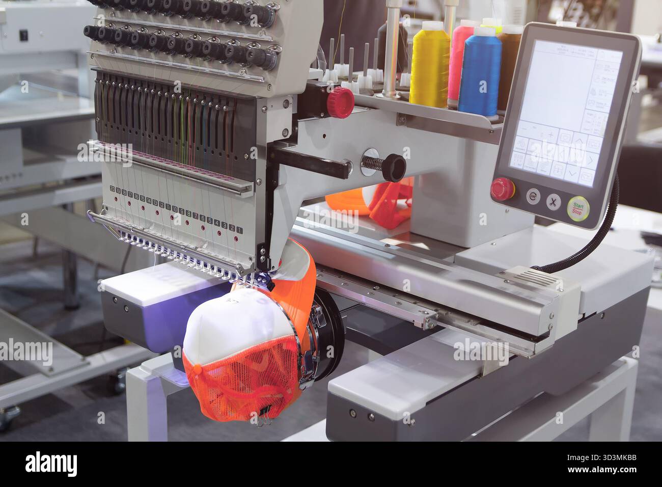 Automatic embroidery machine embroiders on clothes. Garment industry Stock Photo
