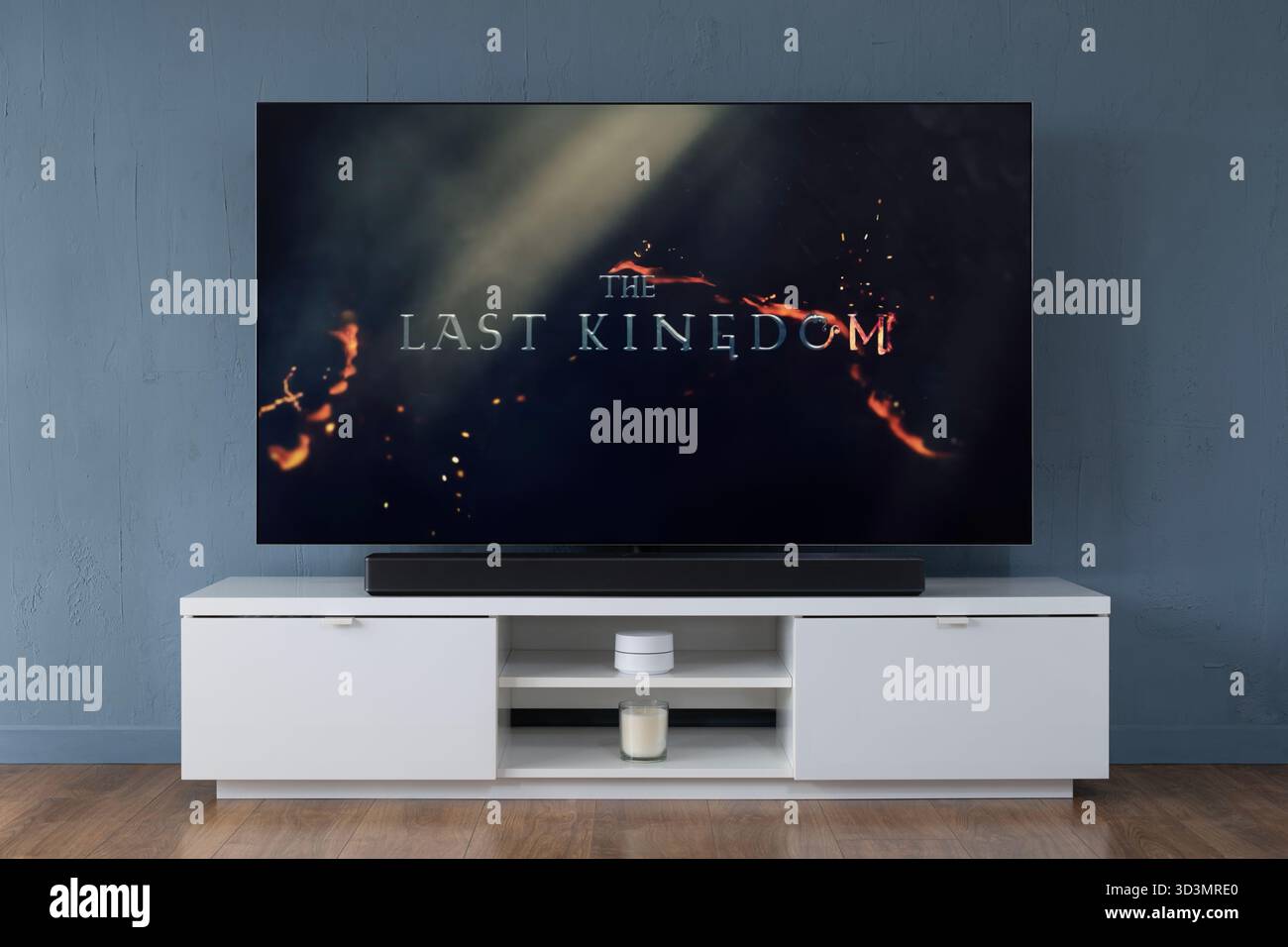 A widescreen OLED television showing the intro scene to the TV series The Last Kingdom, seen in a contemporary living room. Stock Photo