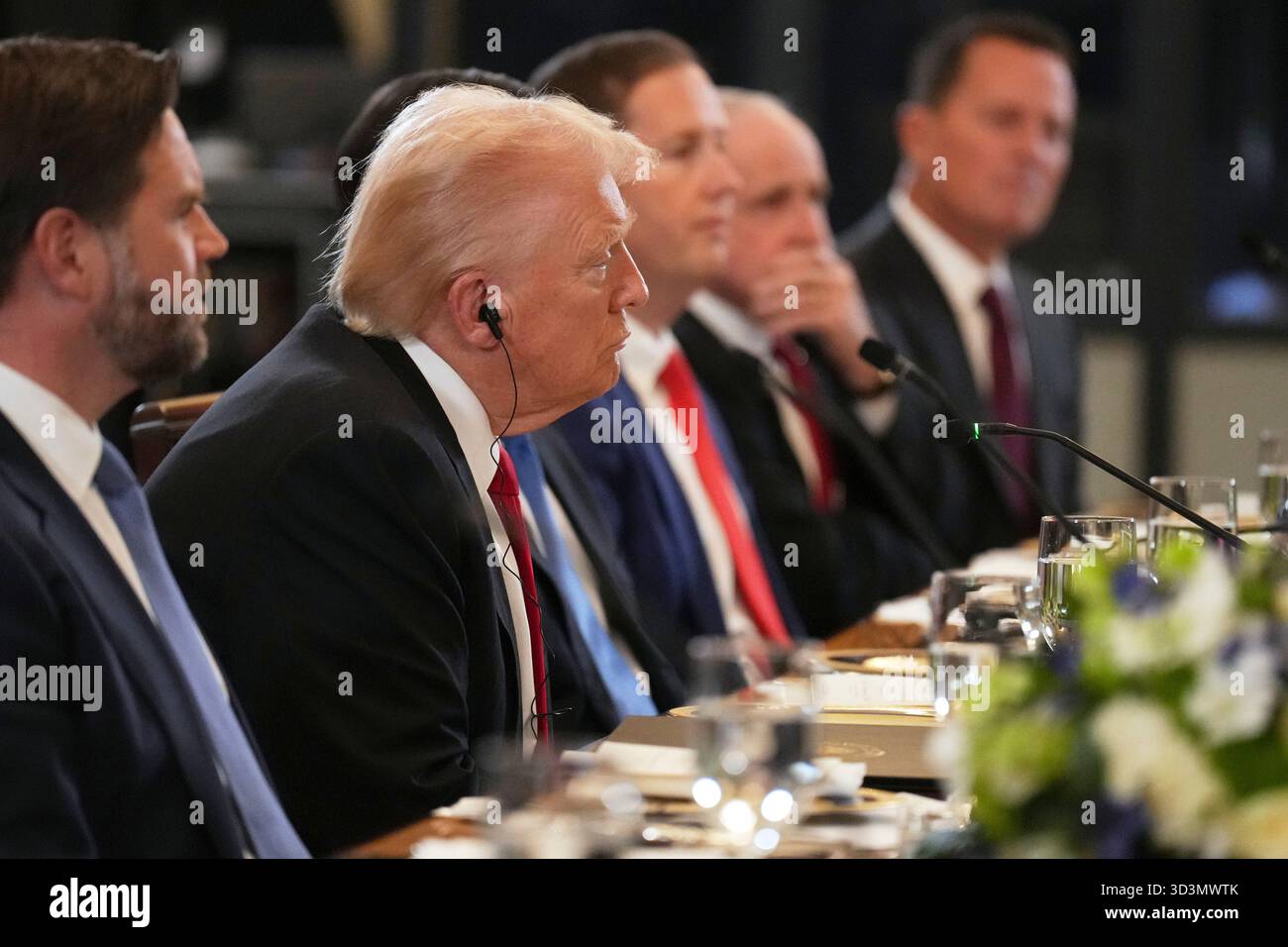President Donald Trump listens alongside Vice President JD Vance, left ...